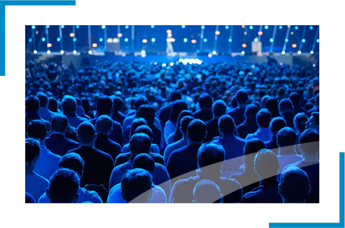 Nighttime corporate event with lights and attendees, showcasing corporate events management