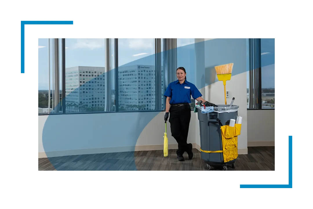woman standing next to garbage can and broom, janitorial services