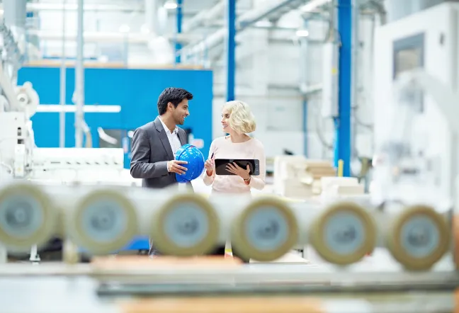 two people talking in an industrial building